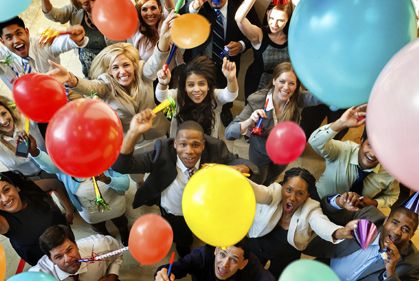 Photo of a people enjoying the party while holding a balloon