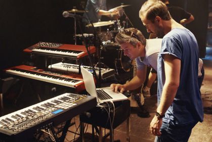 A picture of two men busy while looking at the laptop